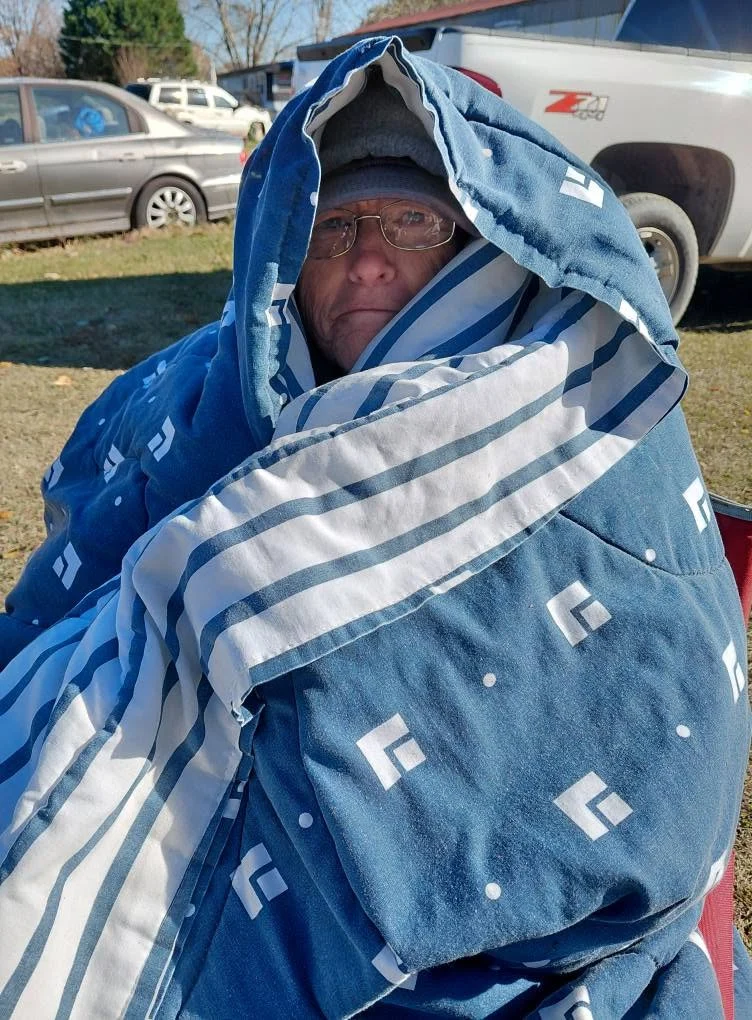 A bundled-up participant enjoying a lighthearted moment outdoors