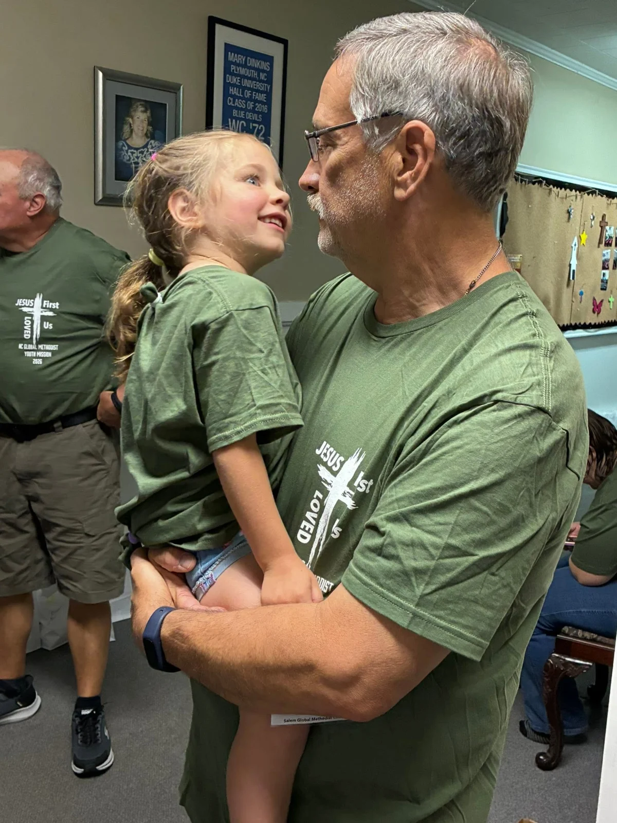 An adult and child sharing a happy moment indoors
